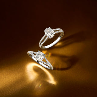 Two Royal Asscher Pavé diamond engagement rings on a golden surface, featuring closely set diamonds and elegant sparkle.