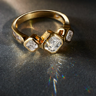 Royal Asscher Cut bezel engagement ring with three stones in 18k yellow gold