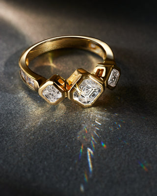 Royal Asscher Cut bezel engagement ring with three stones in 18k yellow gold